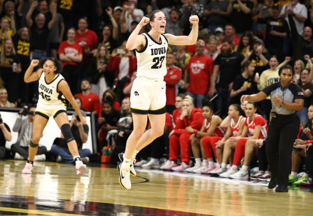 IOWA CITY, IOWA- MARCH 3:  Guard Caitlin Clark #22 of the Iowa Hawkeyes celebrates after breaking Pete Maravichs all-time NCAA scoring record during the first half against the Ohio State Buckeyes at Carver-Hawkeye Arena on March 3, 2024 in Iowa City, Iowa.  (Photo by Matthew Holst/Getty Images)