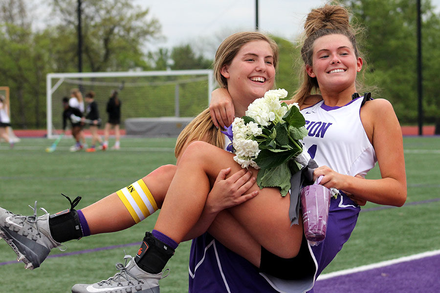 Sophomore Avery Myricks hold her sister senior Keali Myrick after the Varsity lacrosse game and senior night April 29. The team beat Lee's Summit West 12-8. 