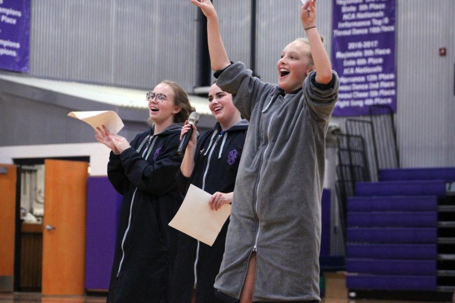 As students filled the bleachers, seniors Grace Parrott, Allie Dierks and Brie Bowes cheered their welcomes Friday, Nov. 22. 