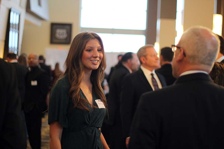 Junior Anna McQueeny has a conversation with her father at the annual Father Daughter dance Feb. 9. This year's Father-Daughter dance was held at the Sheraton in Overland Park, KS.