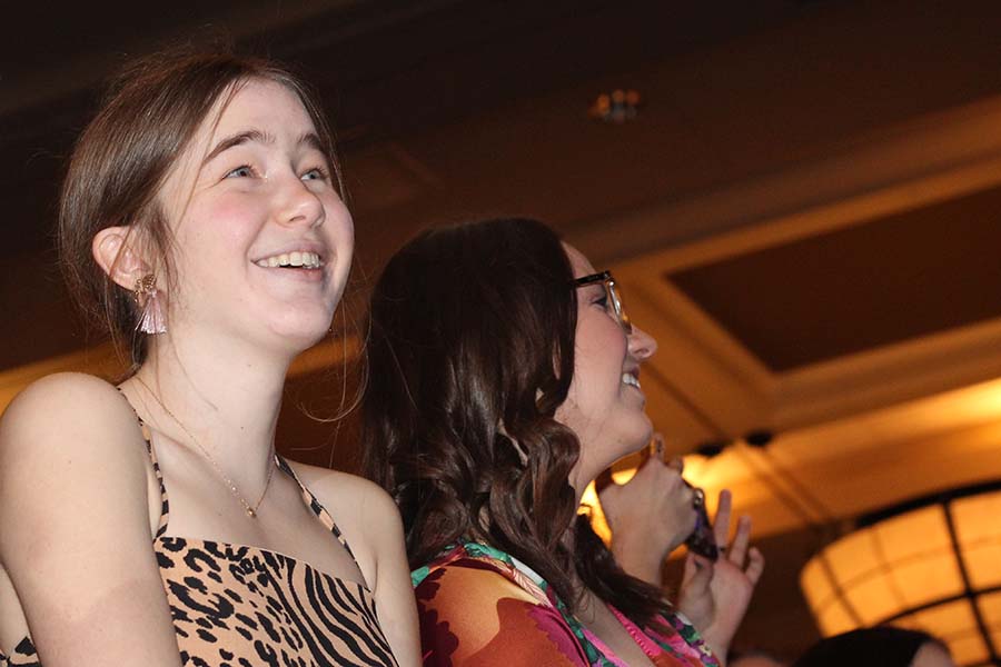Senior Lilly Denney laughs at her father while he sings We Are the Champions by Queen during the annual Father-Daughter dance on Feb. 9. As tradition, fathers of seniors students serenade their daughter and senior students serenade their fathers. 