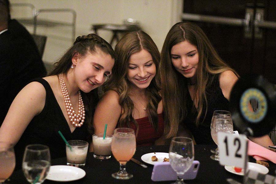 Sophomores Emily Joice, Kate McCarthy and Lauren Shaw pose for a selfie during the annual Father Daughter dance Feb. 9. Coinciding with this years Pink Ladies theme, burger sliders, mac and cheese and potato chips were served for dinner with chocolate chip cookies and a milkshake bar for dessert.