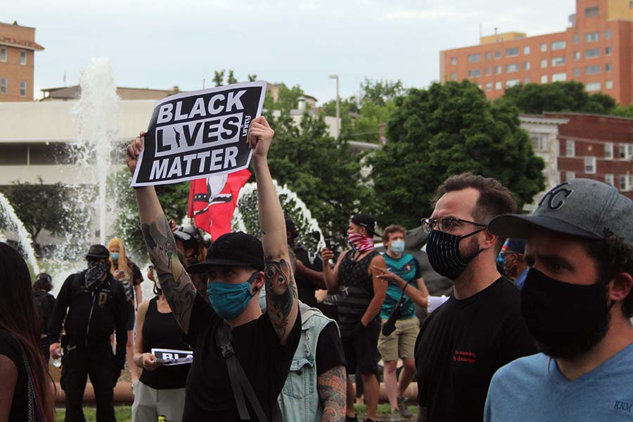 A protester holds up a sign saying Black Lives Matter in front of the J.C. Nichols Memorial Fountain during the protest against police brutality on May 30.