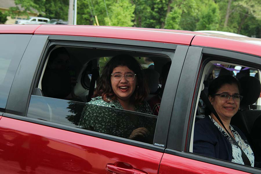 Senior Maya Bair cries as she drives past her teachers during the graduation parade in the parking lot on May 21. It was really exciting to see everyone, but I think I was the most excited to see Mrs. Mulkey, Bair said. She was and always is so pure.