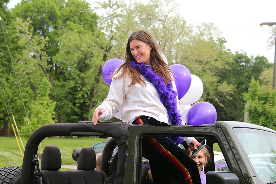Senior Reilly Jackoboice greets her teachers from her car during the graduation parade that took place in the parking lot on May 21.