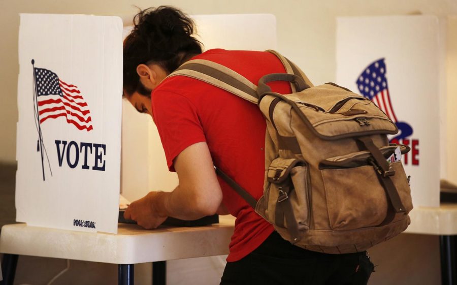  A voter heads to the polls in an April 2017 file image. In Maine, for the first time in U.S. history, a controversial voting system known as "ranked choice" is being used to decide a federal election. 