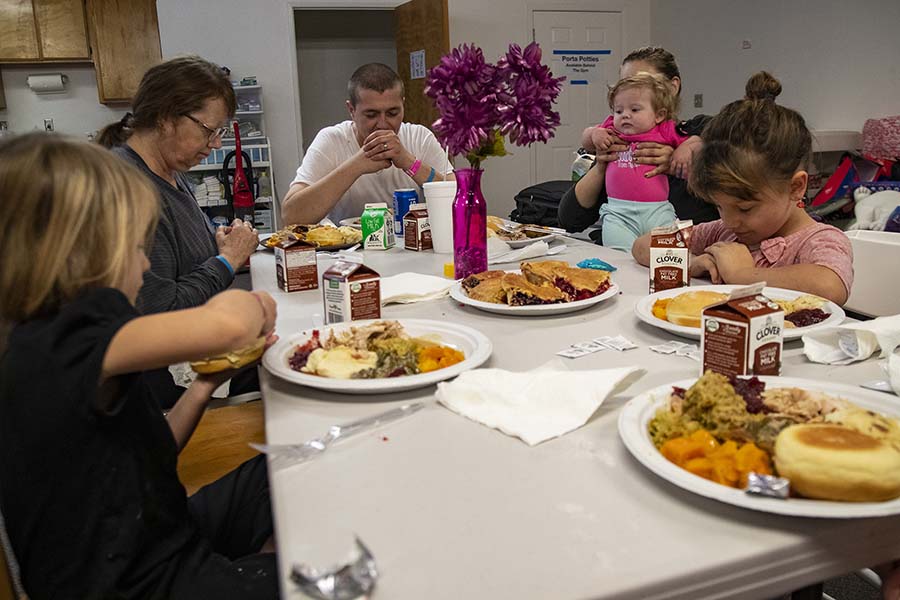 The Swisher family prays before eating Thanksgiving dinner at a church shelter where they have been staying after losing their home in Paradise, Calif., in the Camp fire, on Thursday, Nov. 22, 2018, in Chico, Calif. (Gina Ferazzi/Los AngelesTimes/TNS)