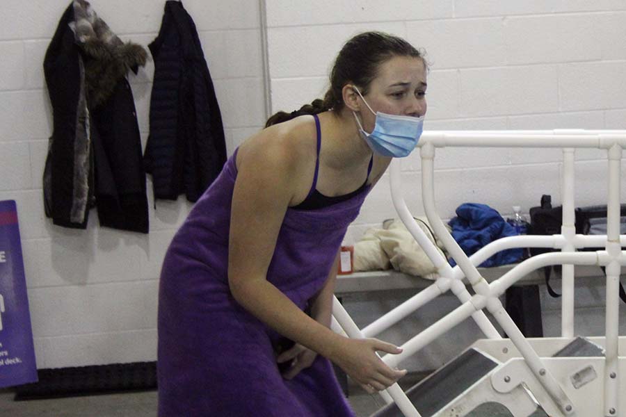 Senior Emma Grojean yells words of encouragement at her team mates during a race at the swim and dive meet against St. Teresas Academy at the Red Bridge YMCA on Jan. 26.