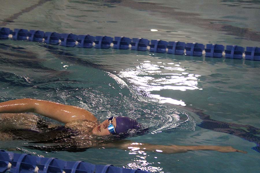 Senior Kate Vankeirsbilck competes in a race during the swim and dive meet against St. Teresa's Academy at the Red Bridge YMCA on Jan. 26.