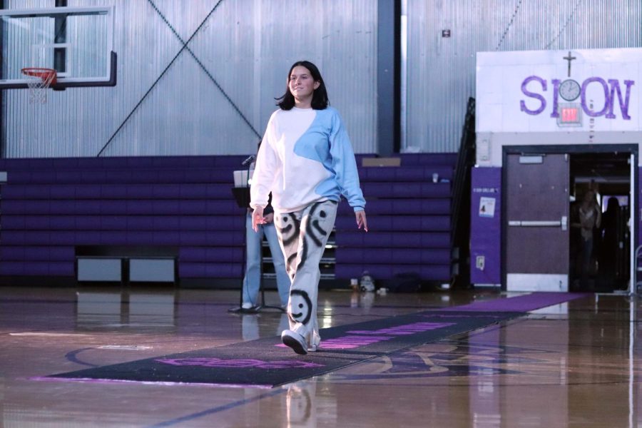 Senior Sabrina Ross shows off her perfected model walk along with her not only thrifted, but upcycled pants, which she painted herself. 