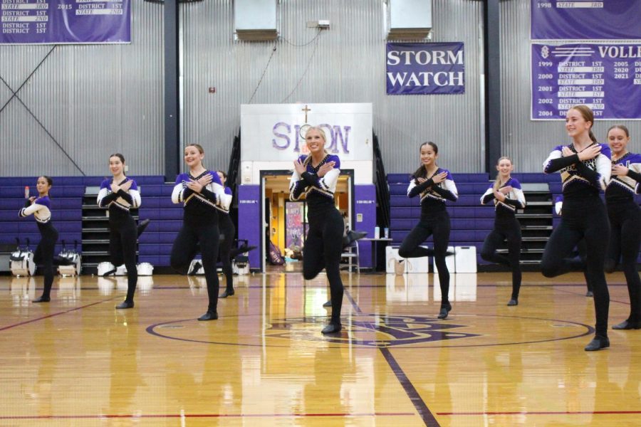 Front and center, junior Ava Townsend and the rest of the dance team perform at Thursday's pep rally 