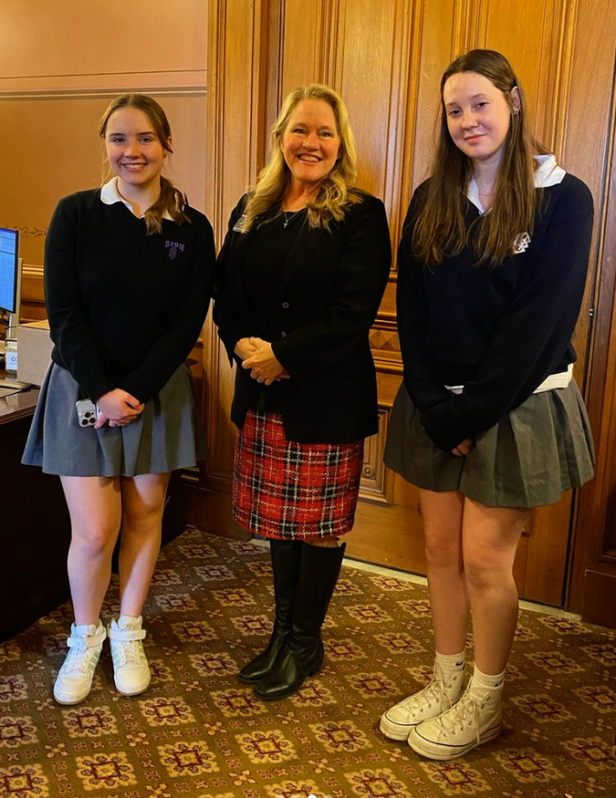 Sophomores Becca Houlehan and Izzy Zschoche stand with Kansas state Representative Mari-Lynn Poskin Monday, Feb. 6. 