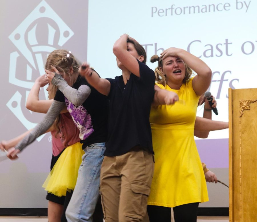 The cast of "Puffs" forms a 'protection circle' as they await the threat to be over. 