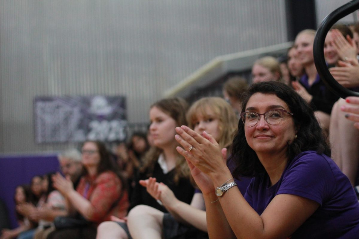 Spanish teacher Solange González and Sion students clap and cheer as the guest singer enters the room. González teaches the Spanish for Heritage Speakers class that planned the celebration.