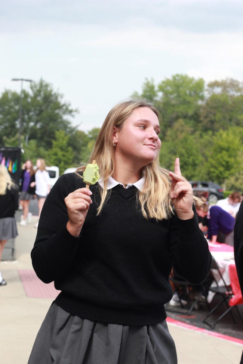 Junior Maeve Glennon dances along to the music as she enjoys her popsicle. This is the first Sion celebration Glennon got to share with her sibling, freshman Neo Glennon.