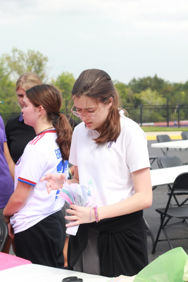 Freshman Sophia Thomas concentrates as she creates a flower out of tissue paper. Paper flowers like this make great year-round decorations.