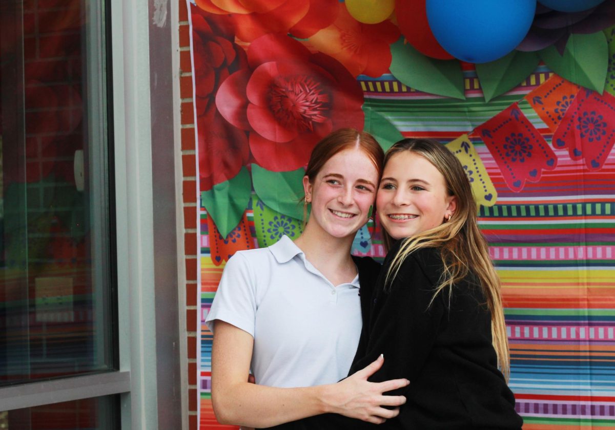 Senior Livvy Cavaliere and freshman Channing Chambers pose at the photo booth before heading out to the celebration. All-school events like the Hispanic Heritage celebration are a great way for students to make friends outside of their grade level.