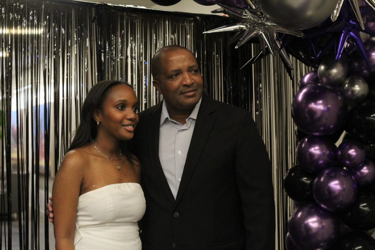 Posing for a photo, senior Zoey Mwarey and her father celebrate their final Sion father daughter dance January 26. 