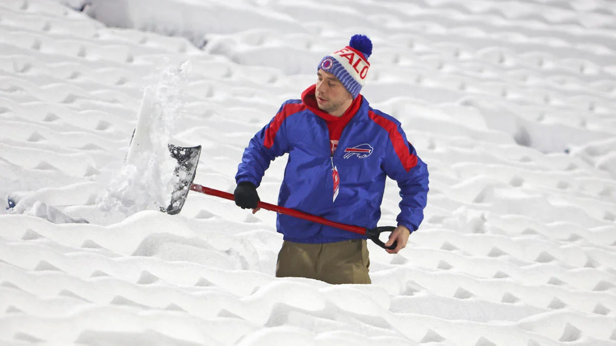 Moving quickly, Buffalo Bills fan shovels snow Jan. 14 in hopes to clear most of the stadium by game time. Hundreds of fans came to help clear the stadium as well in exchange for hotdogs and hot chocolate. 