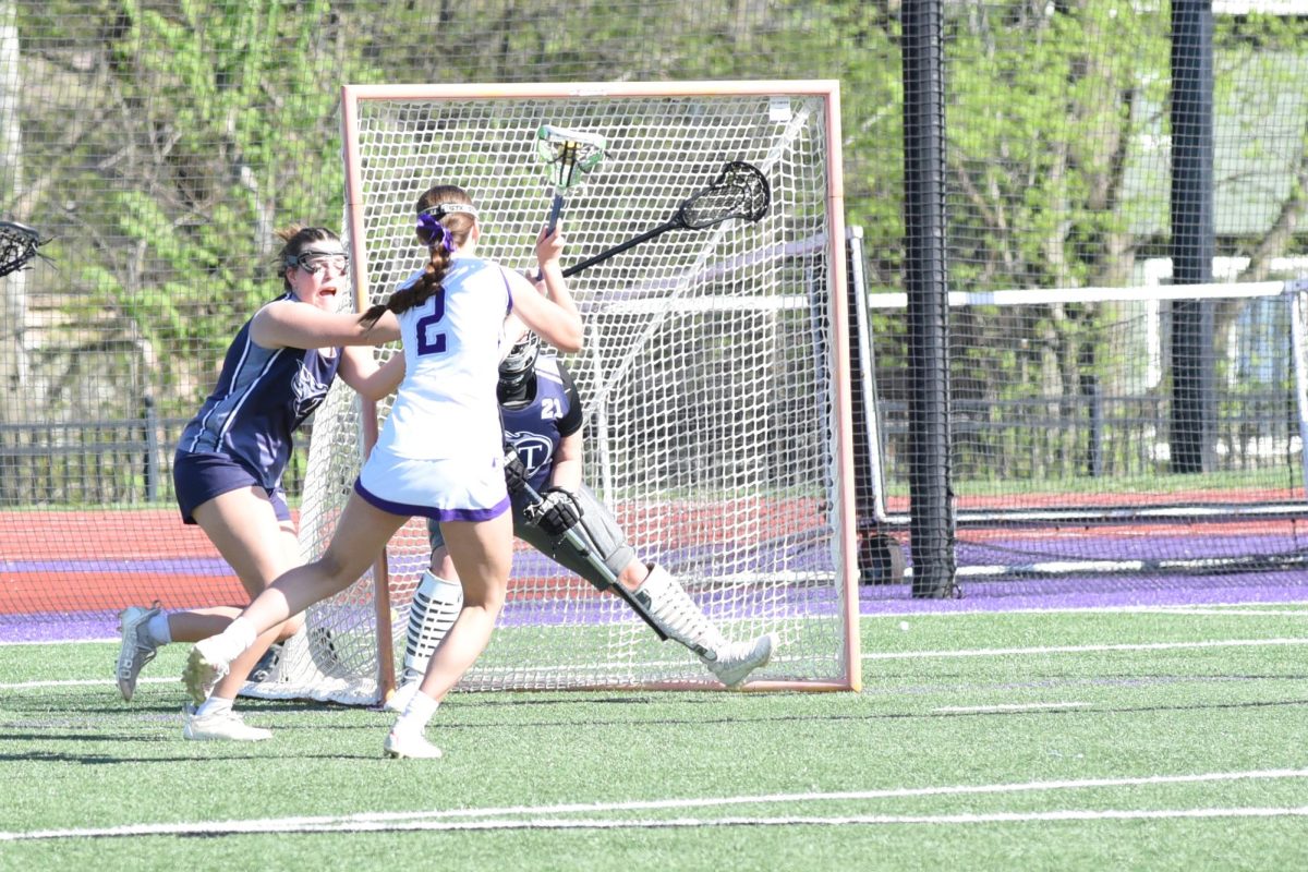 Rolling around the goal, junior Annie Johnson shoots during the Sion v. Lees Summit West game April 17. Johnson scored the game winning goal during a sudden-death overtime. 

Photo submitted by Rodney Miller