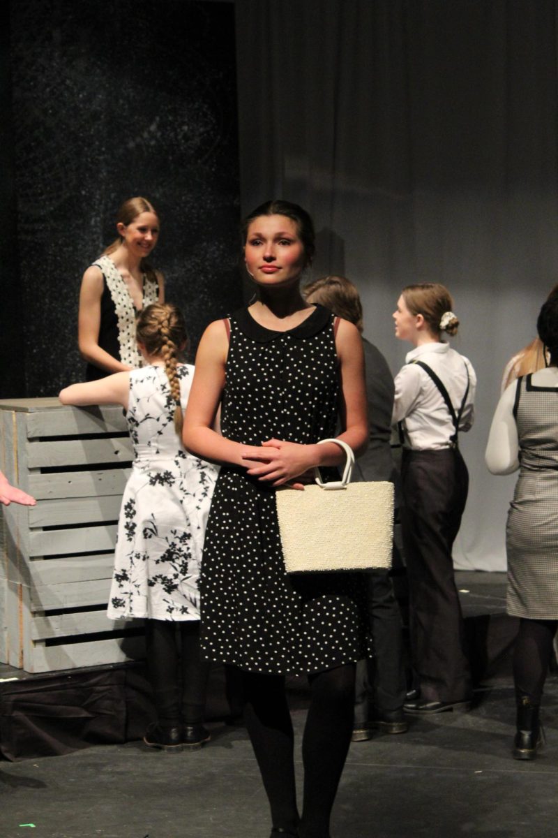 Standing before the audience at the end of the first scene, senior Suzanne Sade stands perfectly still as her character is returned to its former plastic state as a mannequin.