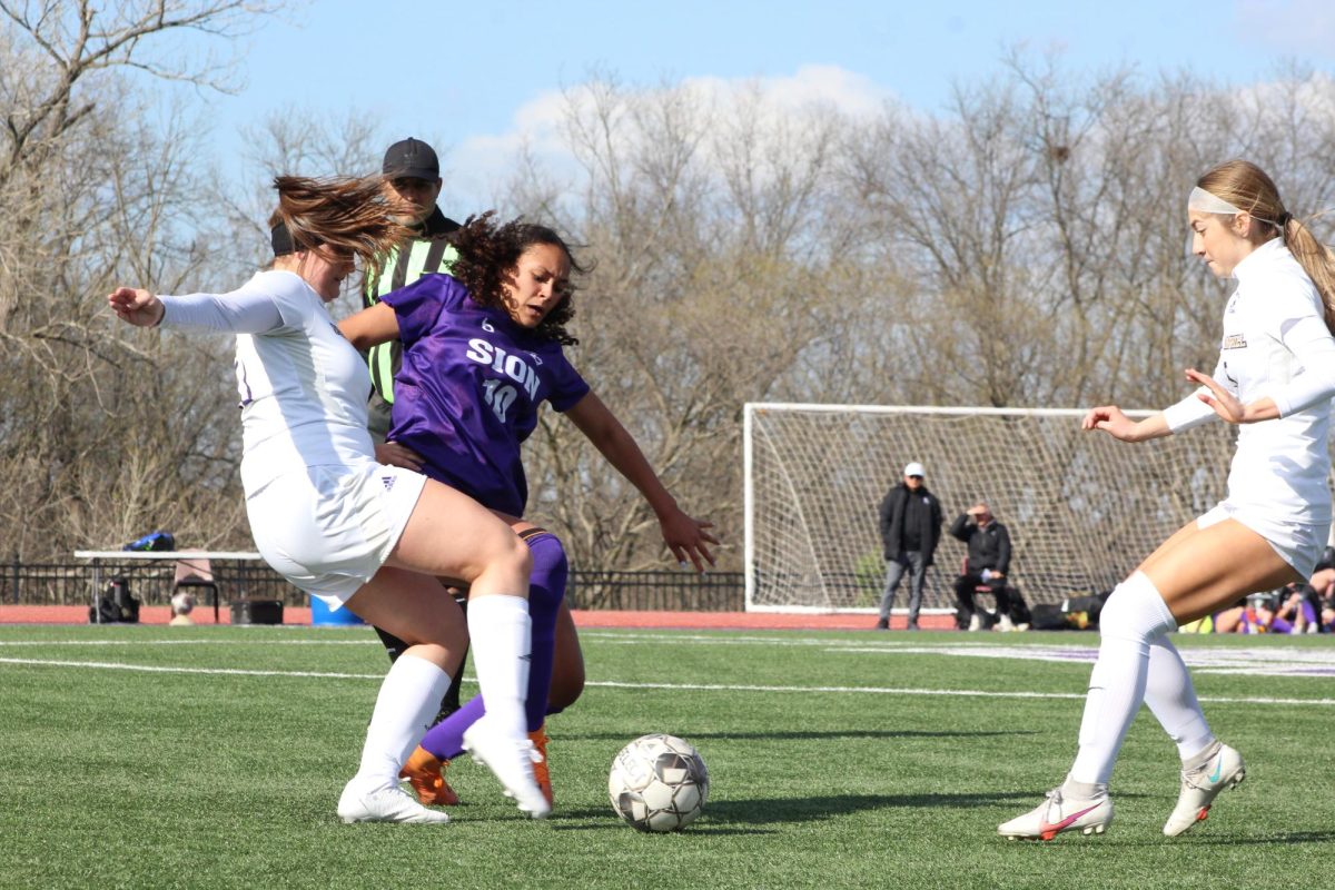 Stealing the ball, sophomore Mia Hebert plays in the varsity soccer game against Pleasant Hill April 4. She scored three of the teams four goals during the game.  